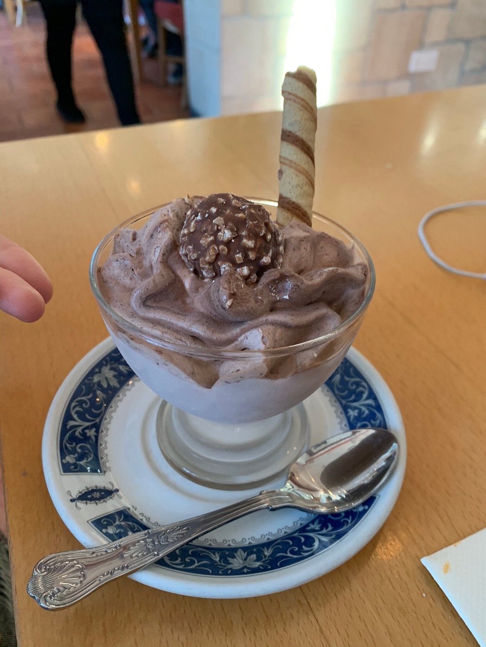Chocolate mousse dessert topped with a Ferrero Rocher and wafer