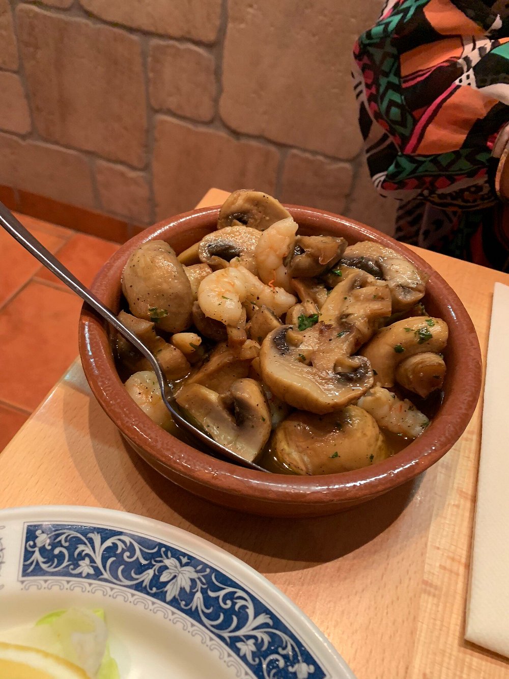 Garlic mushrooms and prawns served in a traditional terracotta dish