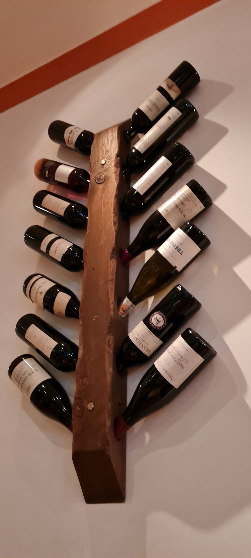 Wooden wall-mounted wine rack with Spanish wines